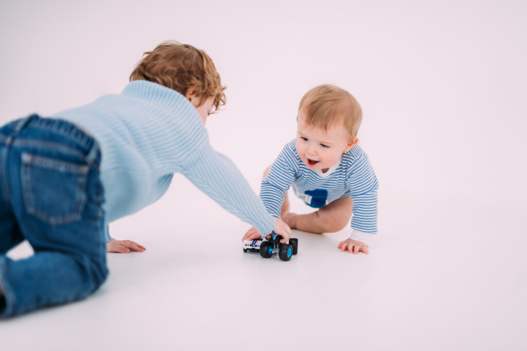 brothers playing with cars